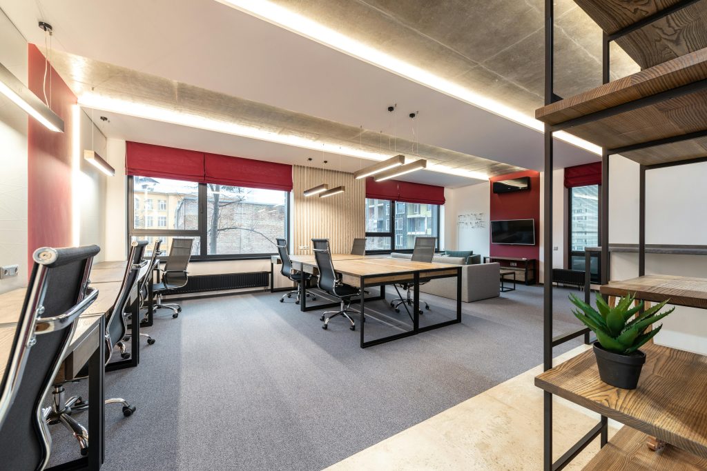 pexels-photo-6899395-6899395 Spacious and contemporary office interior with natural lighting and minimal decor.
