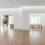 Bright and spacious empty room with wooden flooring, modern design, ideal for interior design inspiration