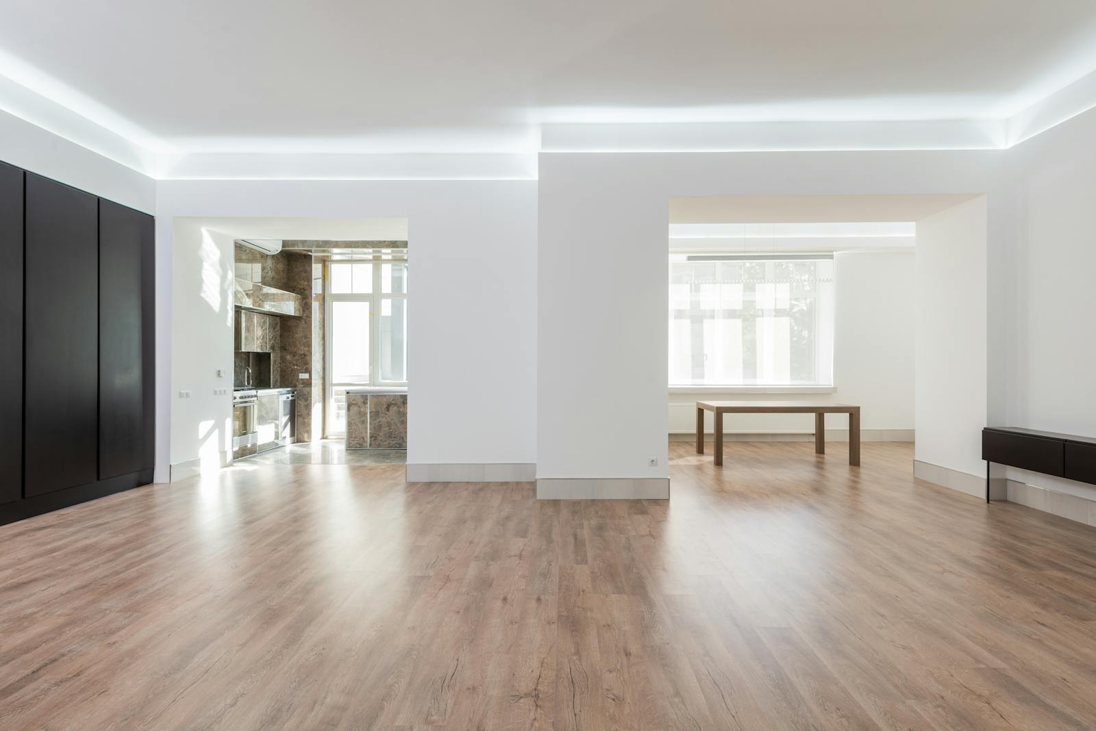 Bright and spacious empty room with wooden flooring, modern design, ideal for interior design inspiration